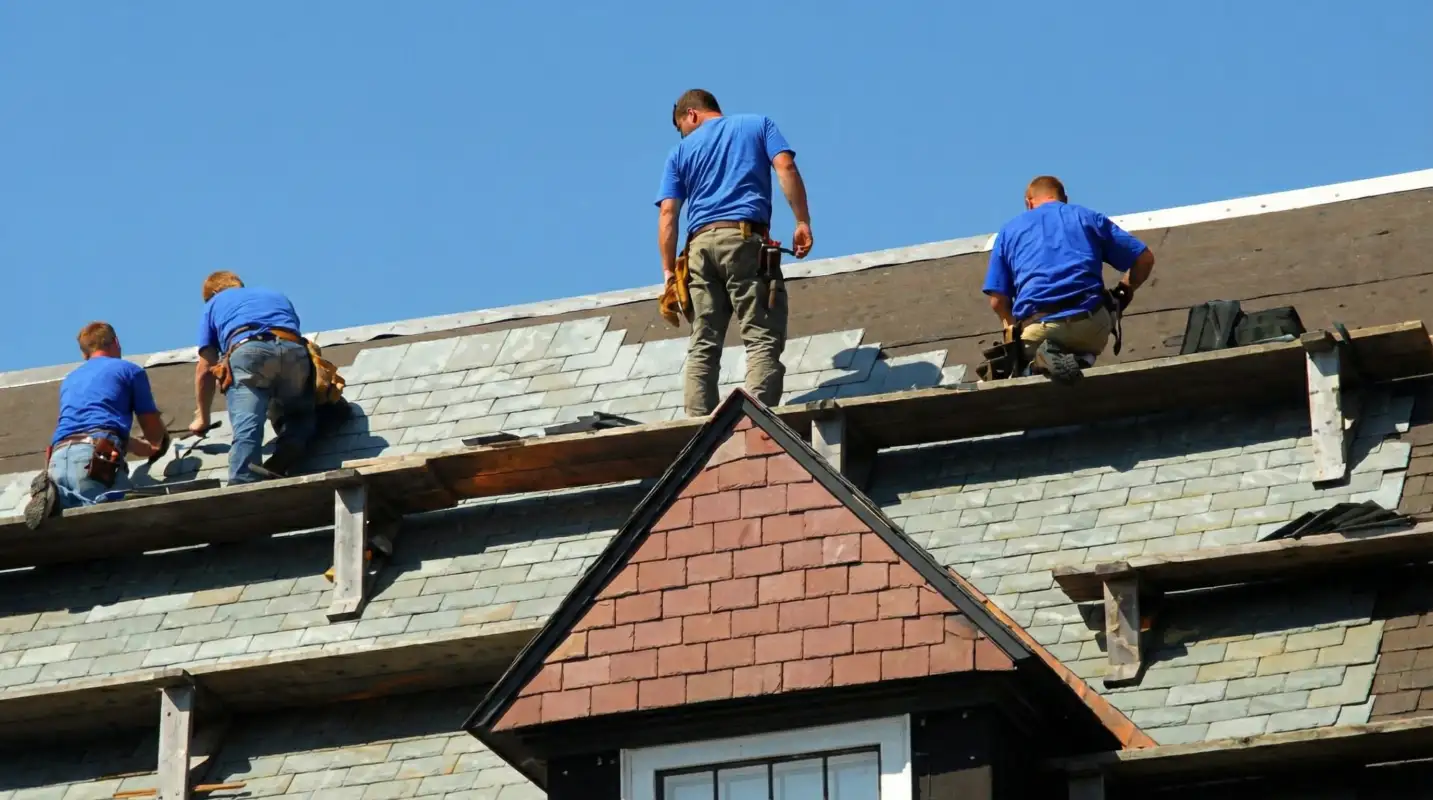 Roof replacement in progress with a team of professional contractors installing new shingles on a residential home in Columbus, OH